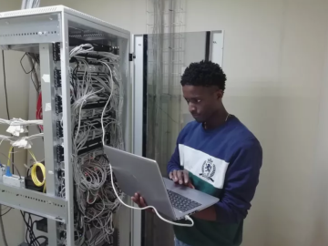 Technician checking executable files in server room